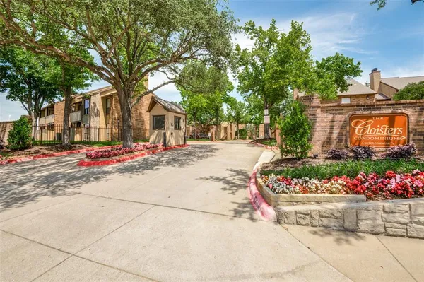 a street view with large trees