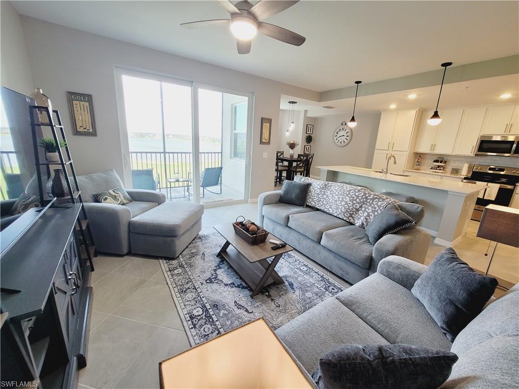 43981 Boardwalk Loop, Unit 2232 Punta Gorda, FL 33982 - Photo 11 of 34 Tiled living room featuring ceiling fan and sink