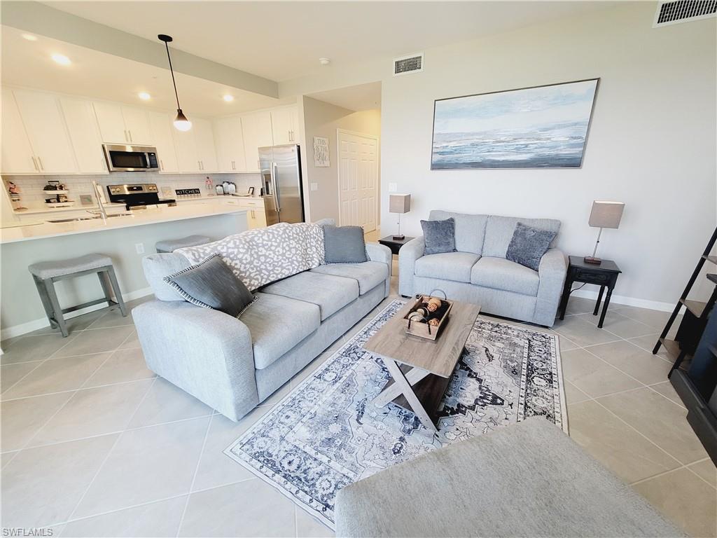 43981 Boardwalk Loop, Unit 2232 Punta Gorda, FL 33982 - Photo 3 of 34 Living room with light tile patterned floors