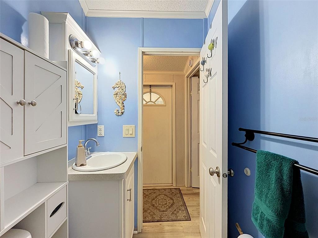 2092 Culbreath Road, Unit A42 Brooksville, FL 34602 - Photo 57 of 70 a bathroom with a sink a mirror a bathtub and shower