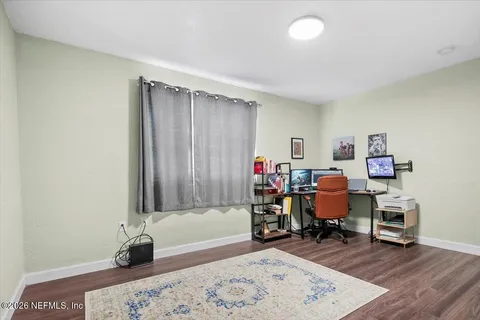 a view of a workspace with furniture and a window