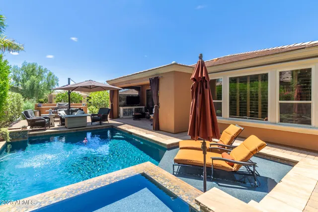 a view of a house with swimming pool and sitting area