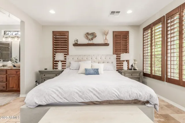 a bedroom with a large bed and a large window