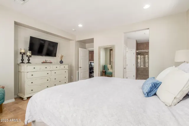 a bedroom with a bed and a flat screen tv in it