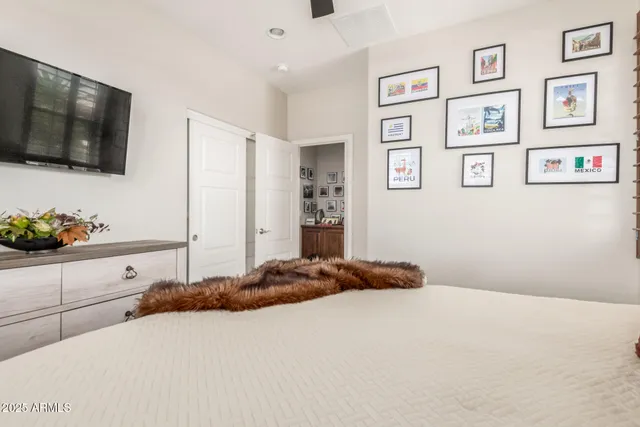 a bedroom with a bed and a flat screen tv