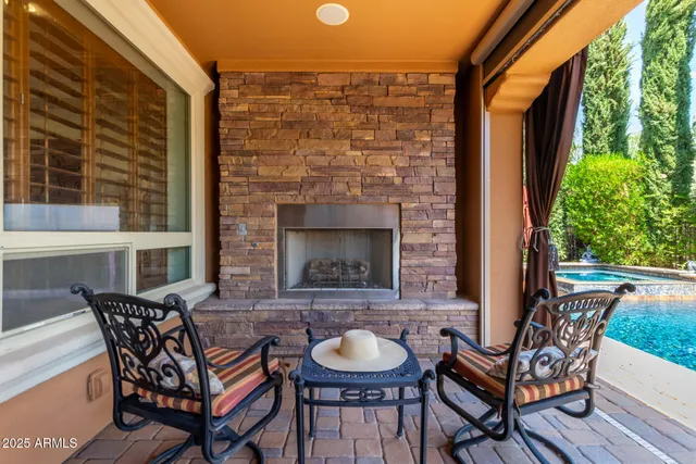 a backyard of a house with fire pit a barbeque oven and a fountain