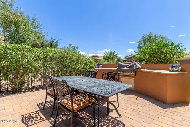 a backyard of a house with table and chairs