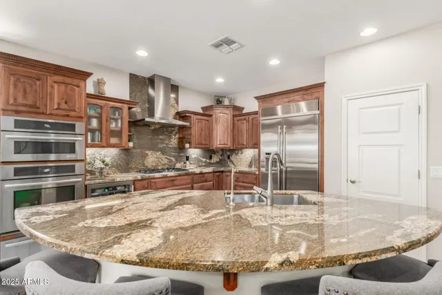 a kitchen with stainless steel appliances granite countertop a sink and cabinets