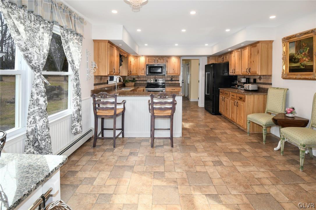 4384 Lehnenberg Road Riegelsville, PA 18077 - Photo 12 of 36 a kitchen with a sink a counter top stainless steel appliances and cabinets
