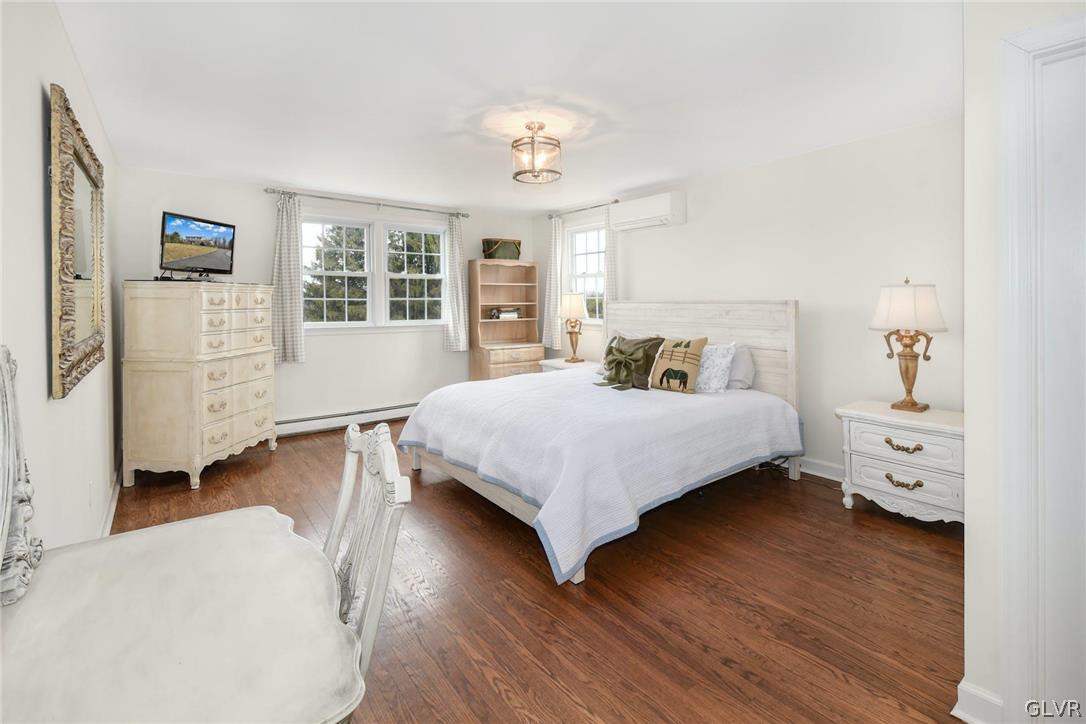 4384 Lehnenberg Road Riegelsville, PA 18077 - Photo 20 of 36 a bedroom with a bed and wooden floor