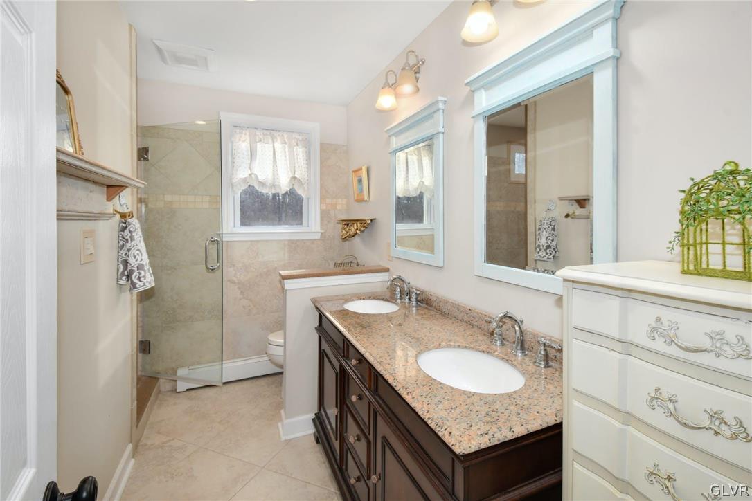 4384 Lehnenberg Road Riegelsville, PA 18077 - Photo 22 of 36 a bathroom with a granite countertop sink and a mirror