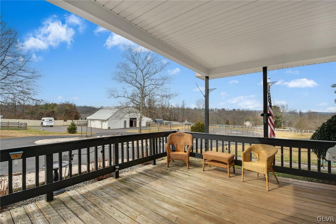 4384 Lehnenberg Road Riegelsville, PA 18077 - Photo 28 of 36 a view of a balcony with wooden floor and fence