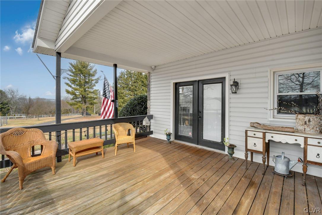 4384 Lehnenberg Road Riegelsville, PA 18077 - Photo 29 of 36 a view of a balcony with chairs and wooden floor