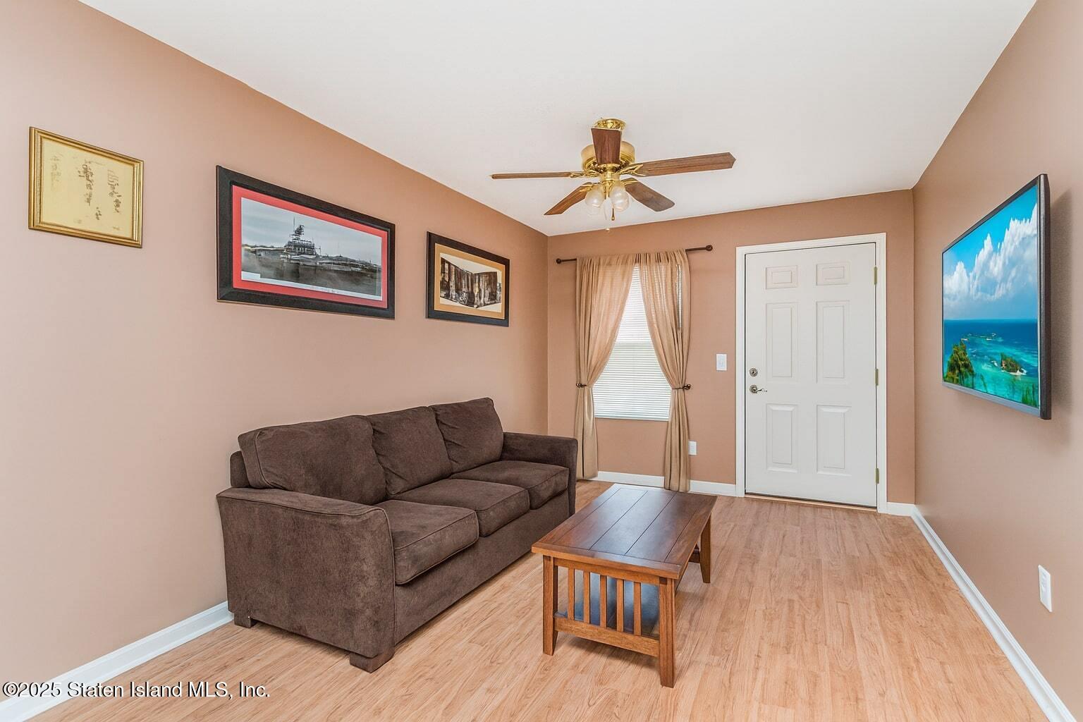 34 Jamie Lane Staten Island, NY 10312 - Photo 3 of 14 a living room with furniture and a wooden floor