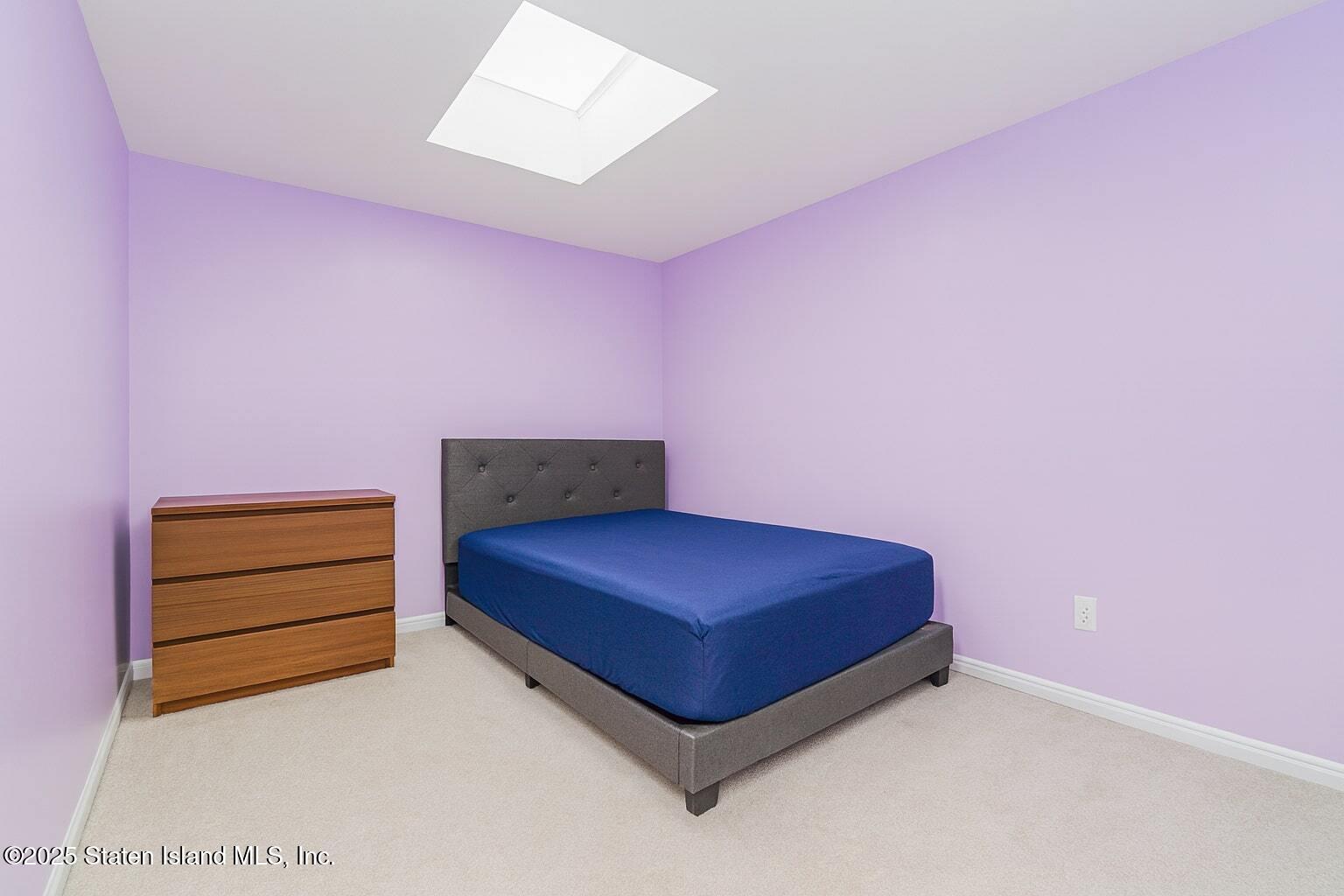 34 Jamie Lane Staten Island, NY 10312 - Photo 5 of 14 a room with a bed and a dresser