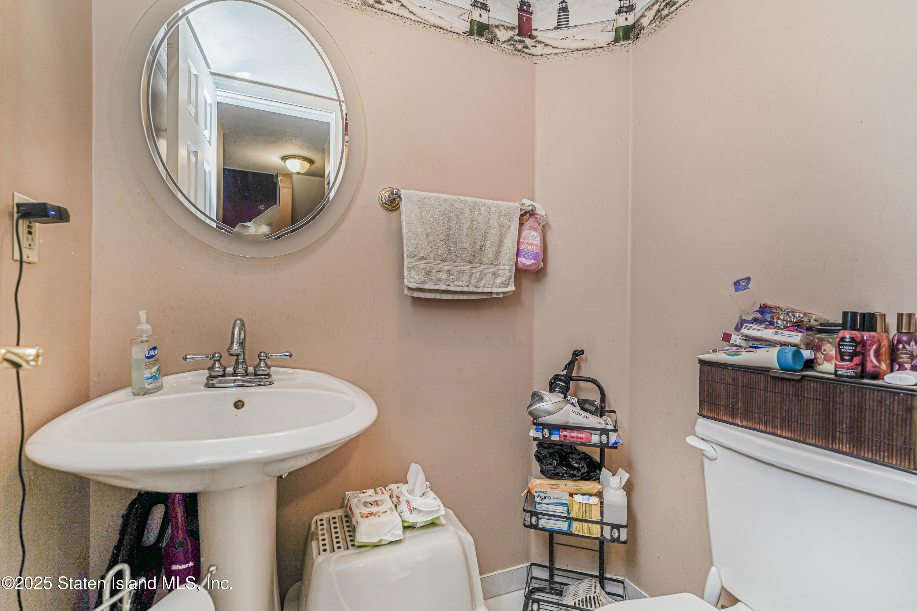 34 Jamie Lane Staten Island, NY 10312 - Photo 7 of 14 a bathroom with a sink and a mirror