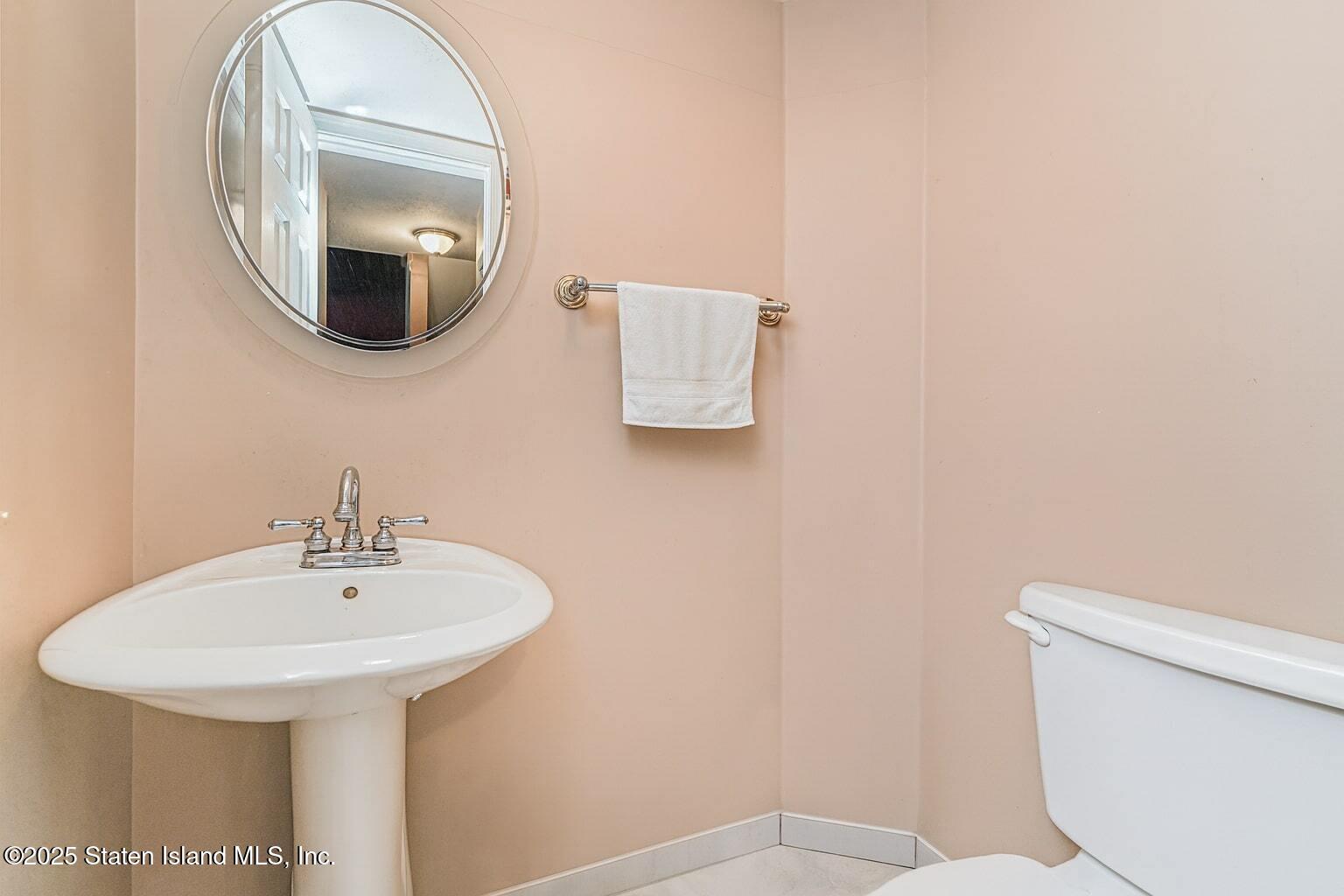 34 Jamie Lane Staten Island, NY 10312 - Photo 8 of 14 a bathroom with a sink and a mirror