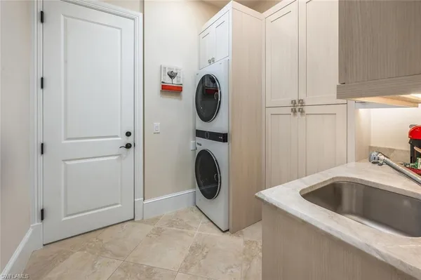a utility room with sink dryer and washer
