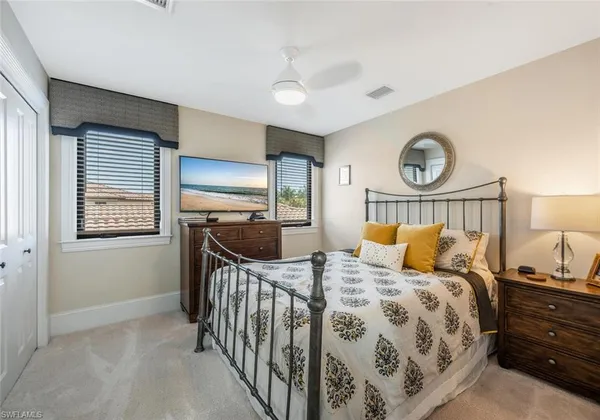 a bedroom with a bed and a chandelier