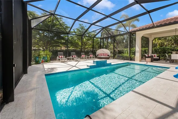 a view of a patio with a table chairs and a backyard
