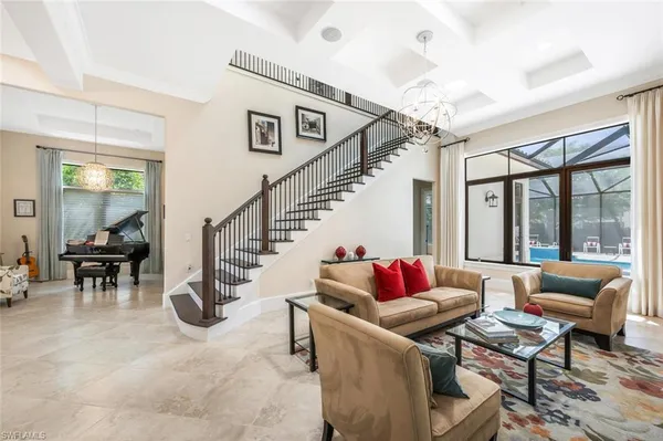 a living room with furniture and a dining table