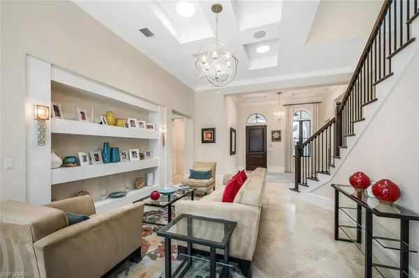 a living room with furniture and a book shelf