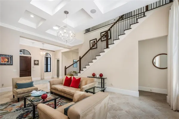a living room with furniture and stairs