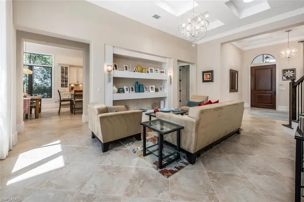 a living room with furniture and a chandelier