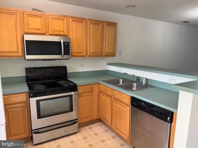 a kitchen with granite countertop a stove top oven microwave and cabinets