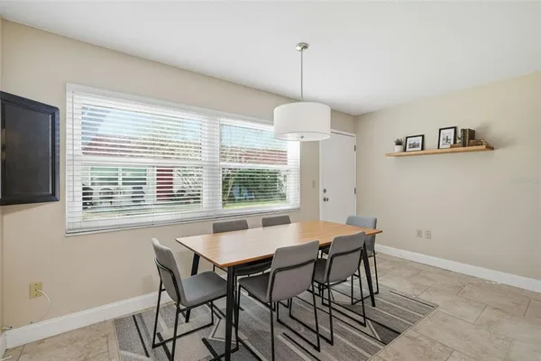 a view of a dining room with a table and chairs