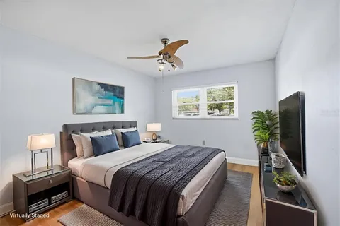 a view of room with hardwood floor and ceiling fan