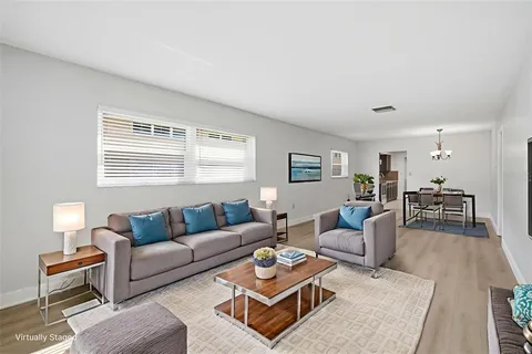 a living room with furniture a lamp and a window