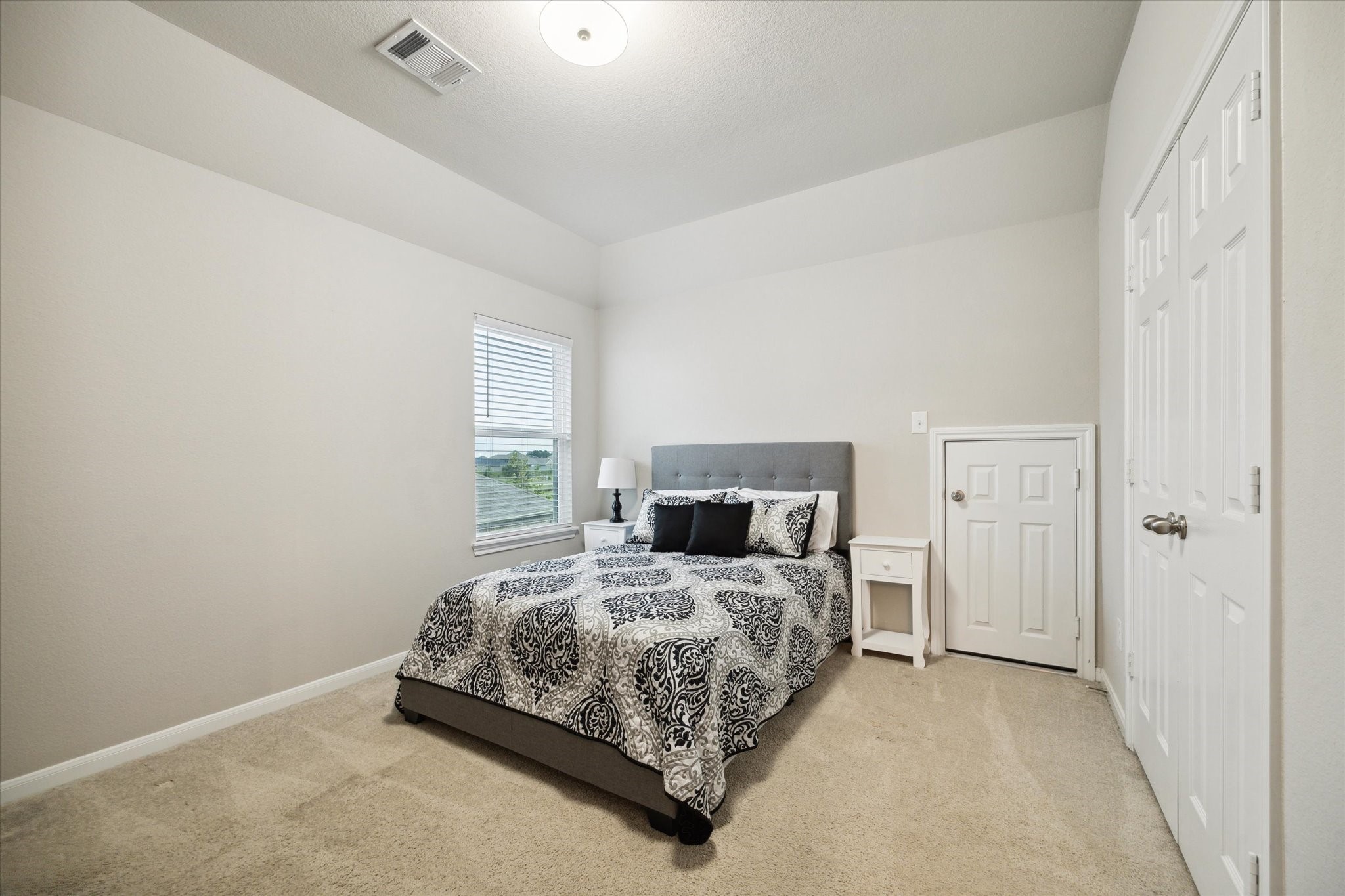 17218 Roxburgh Lake Lane Hockley, TX 77447 - Photo 23 of 36 a bedroom with a bed and a window