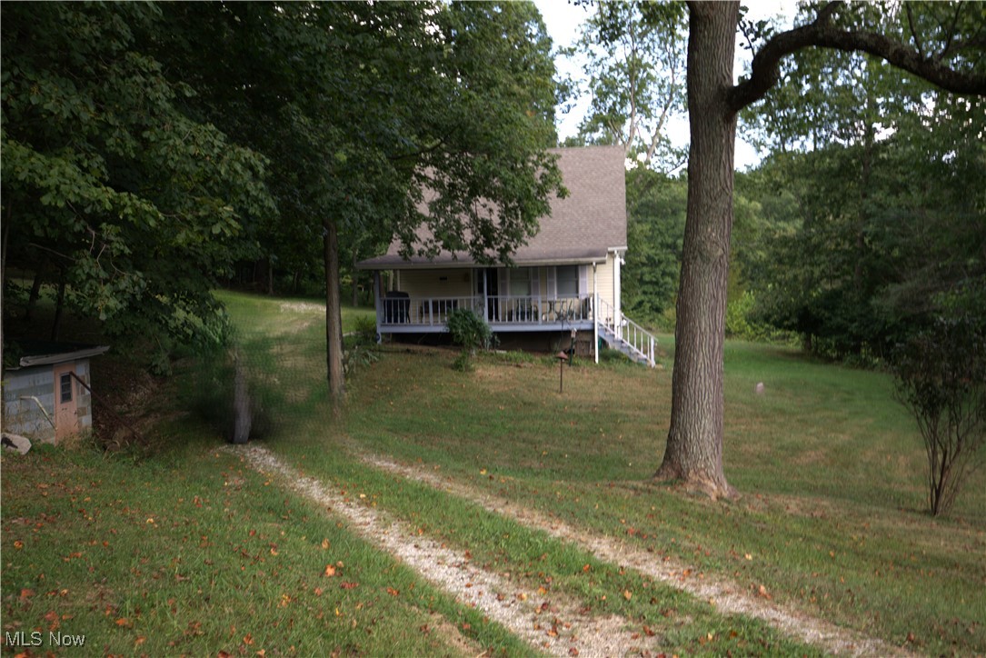 22760 Roy Croy Road Senecaville, OH 43780 - Photo 46 of 46 View of front of property with a front lawn, a porch, and view of wooded area
