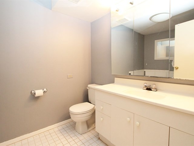 23 Crescent Road Lake Zurich, IL 60047 - Photo 12 of 18 a bathroom with a sink a toilet and mirror