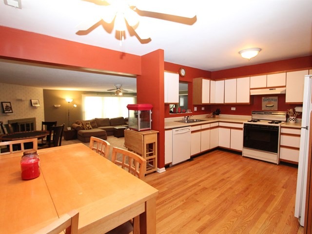 23 Crescent Road Lake Zurich, IL 60047 - Photo 6 of 18 a kitchen with stainless steel appliances kitchen island granite countertop a stove top oven a sink a dining table and chairs