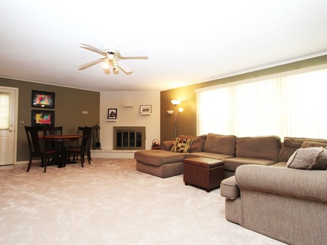 23 Crescent Road Lake Zurich, IL 60047 - Photo 7 of 18 a living room with furniture a fireplace and a large window