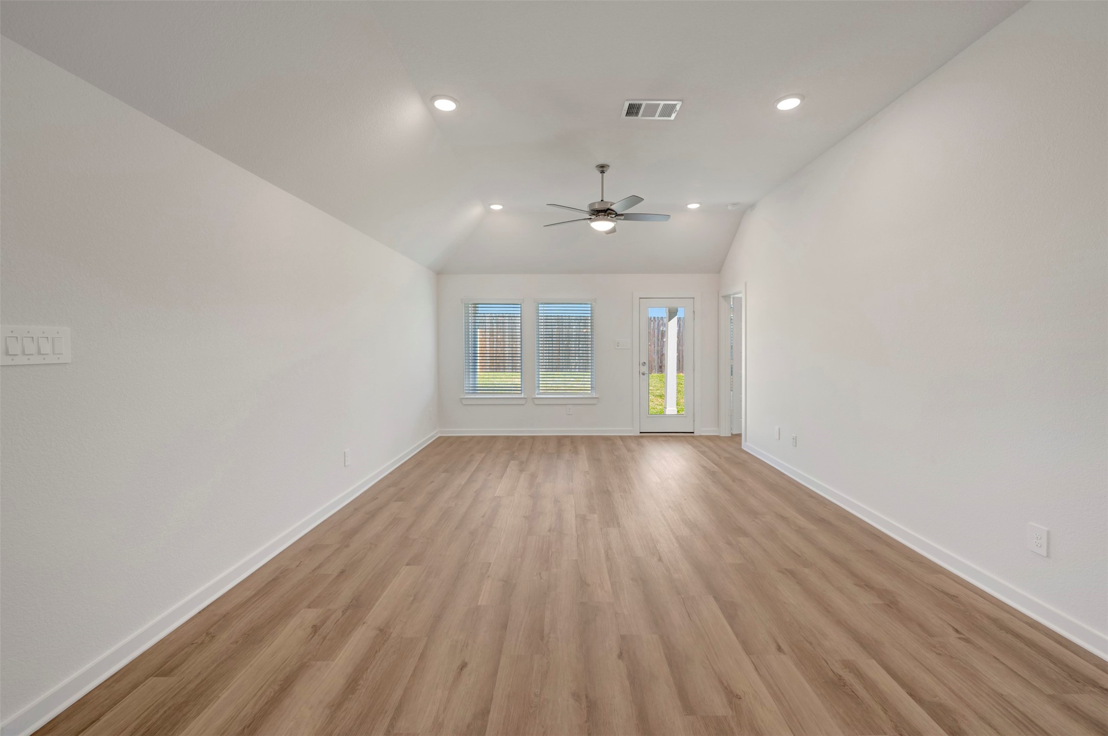 633 Falling Cave Drive Willis, TX 77378 - Photo 16 of 42 an empty room with wooden floor and windows