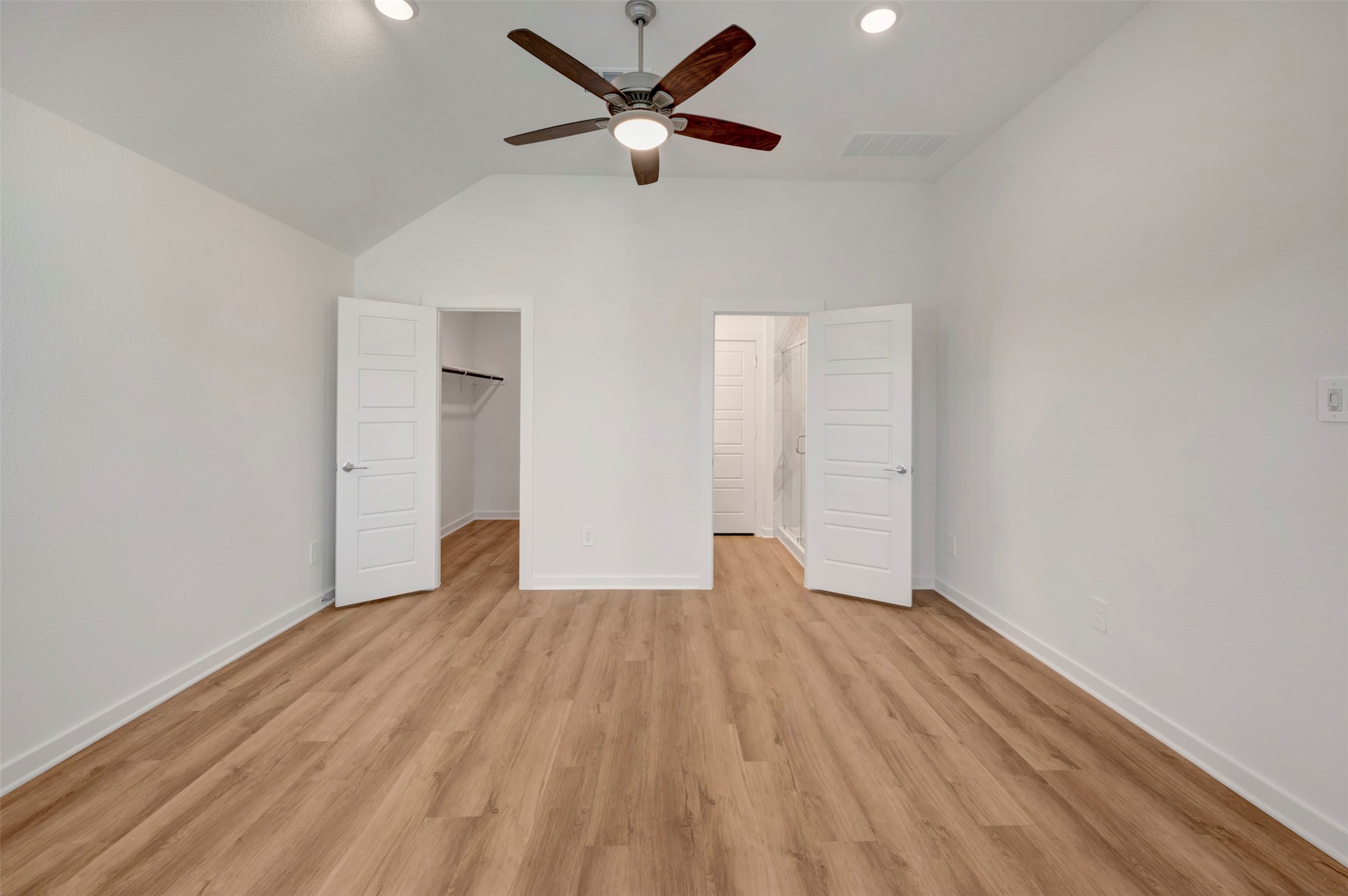 633 Falling Cave Drive Willis, TX 77378 - Photo 33 of 42 an empty room with wooden floor ceiling fan and windows
