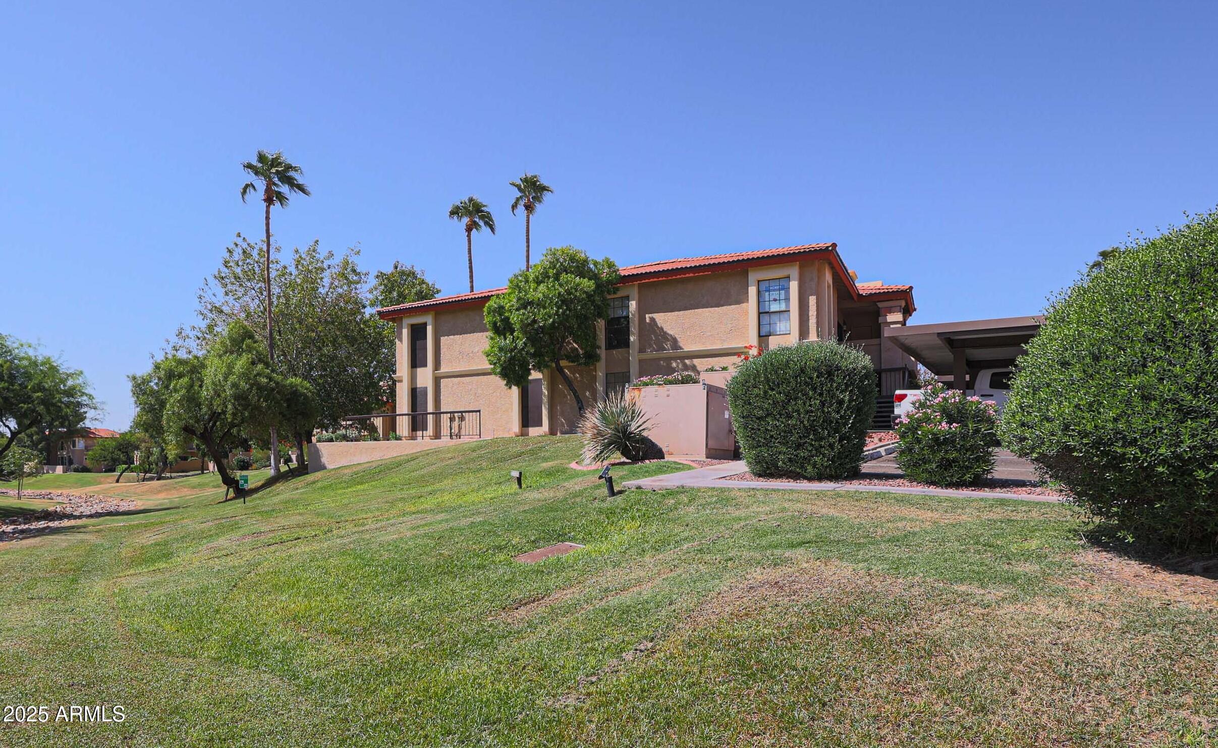 10410 North Cave Creek Road, Unit 2220 Phoenix, AZ 85020 - Photo 1 of 33 a front view of a house with a yard