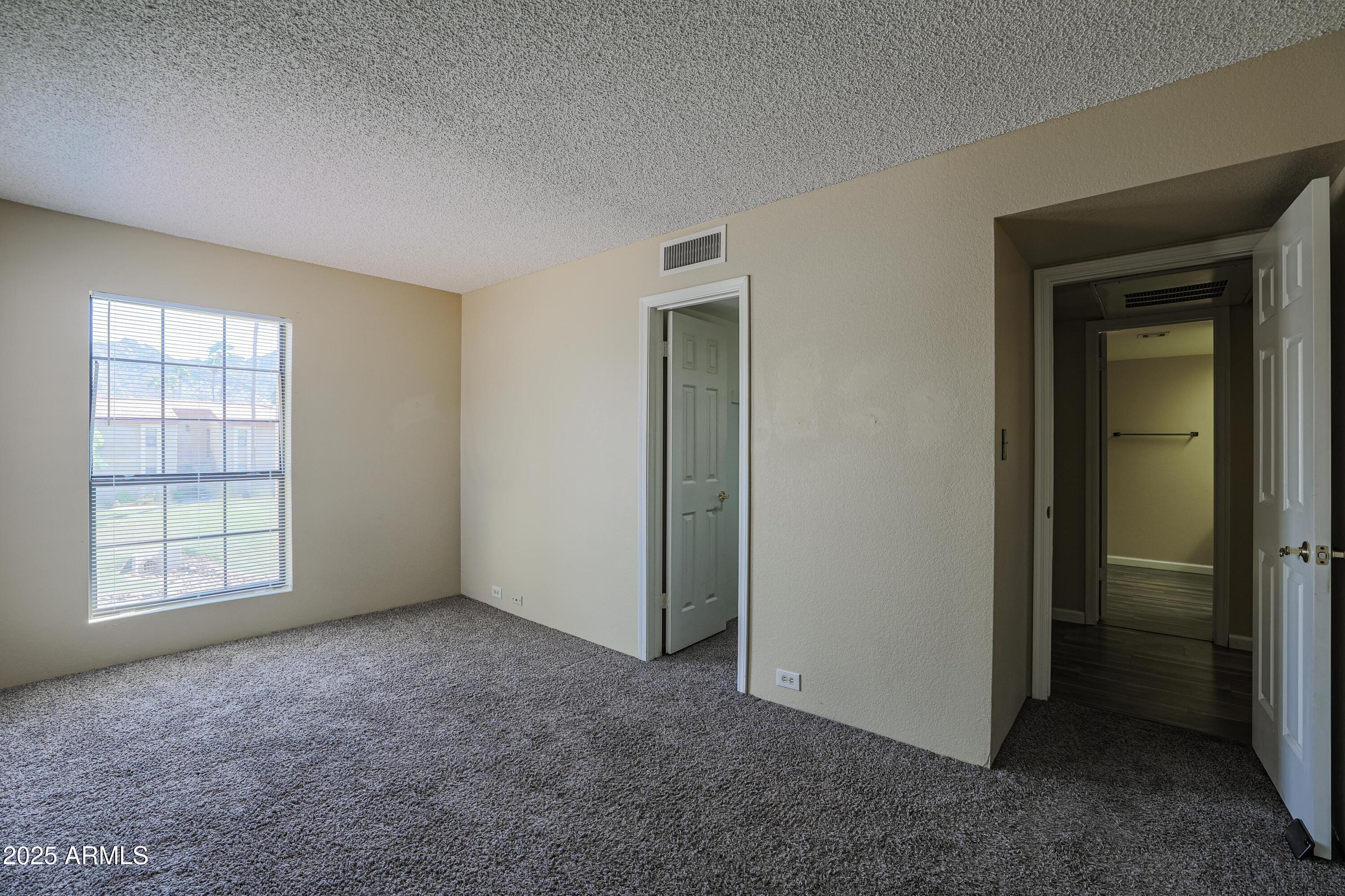 10410 North Cave Creek Road, Unit 2220 Phoenix, AZ 85020 - Photo 18 of 33 an empty room with windows and closet
