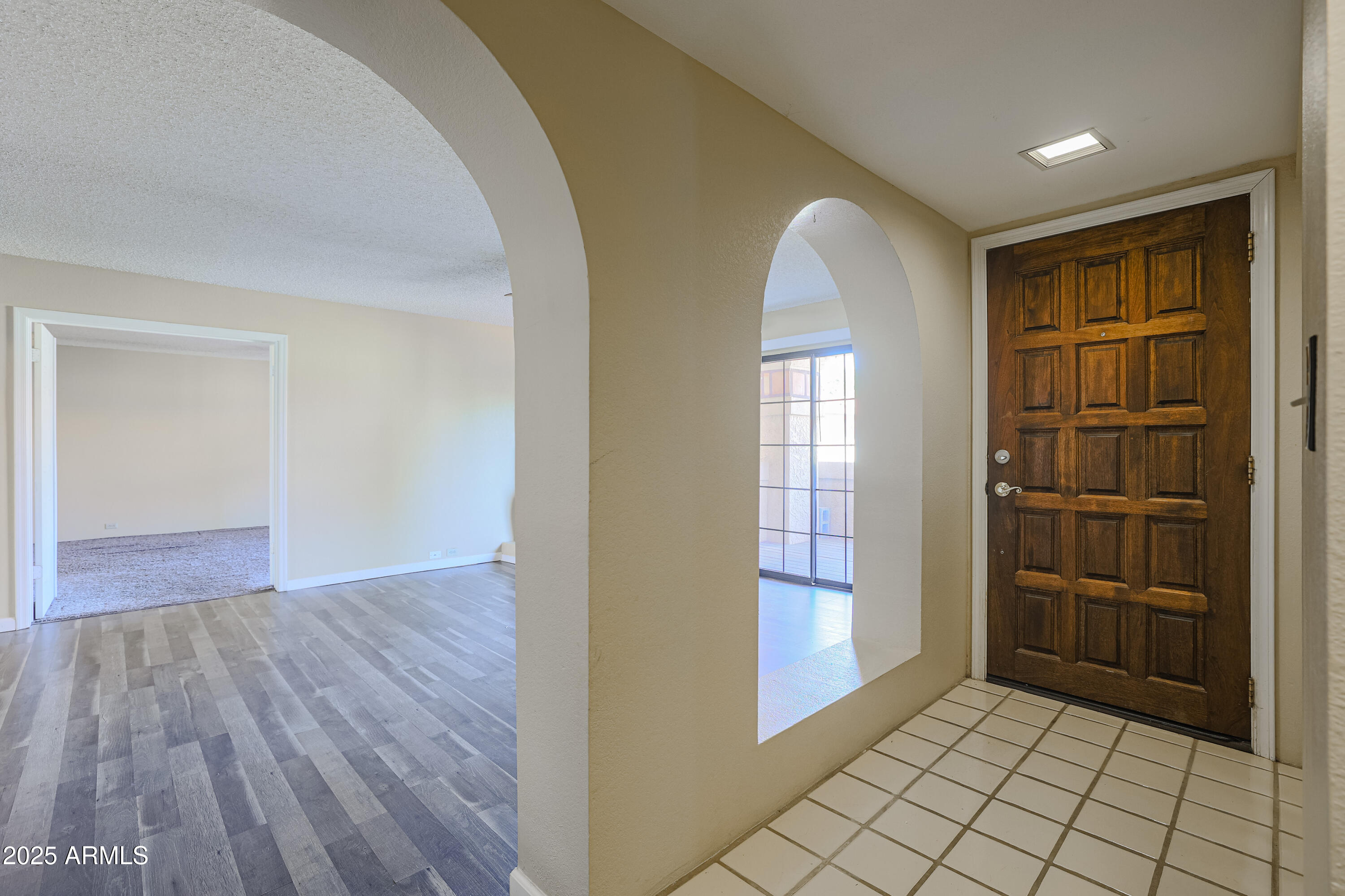 10410 North Cave Creek Road, Unit 2220 Phoenix, AZ 85020 - Photo 2 of 33 an empty room with wooden floor cabinet and windows