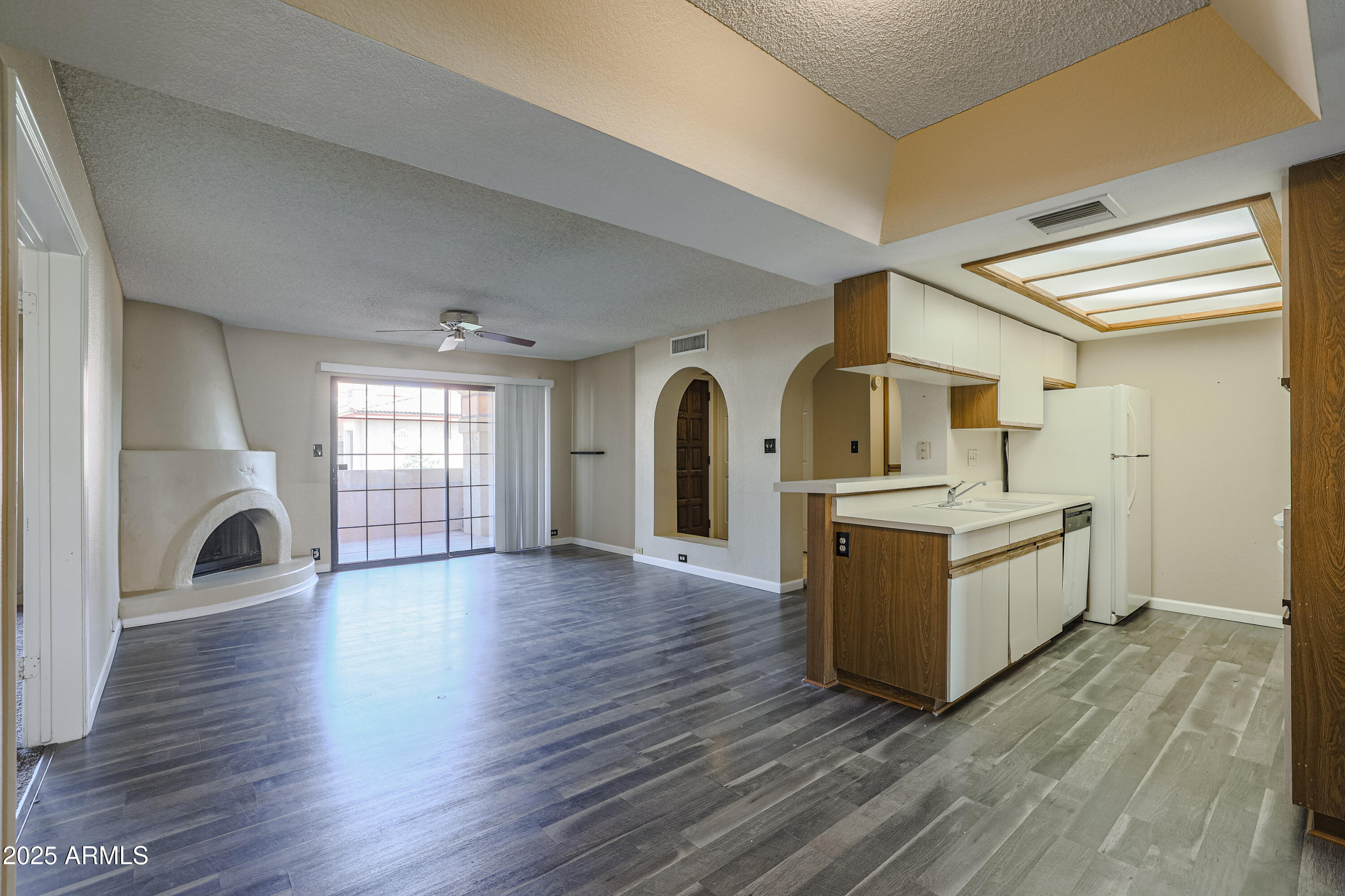 10410 North Cave Creek Road, Unit 2220 Phoenix, AZ 85020 - Photo 4 of 33 a view of living room with kitchen island wooden floor and window