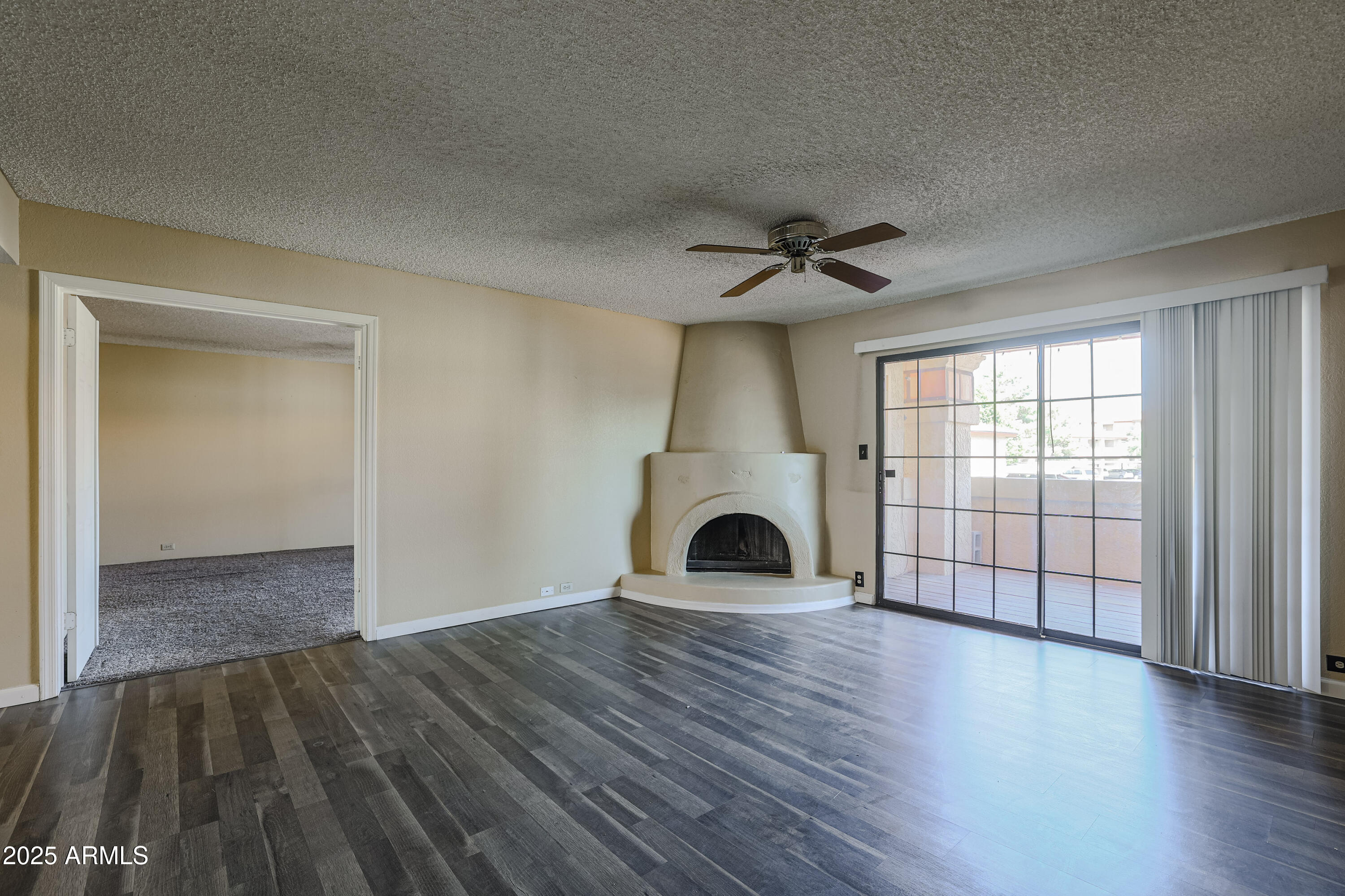 10410 North Cave Creek Road, Unit 2220 Phoenix, AZ 85020 - Photo 5 of 33 a view of empty room with wooden floor and fan