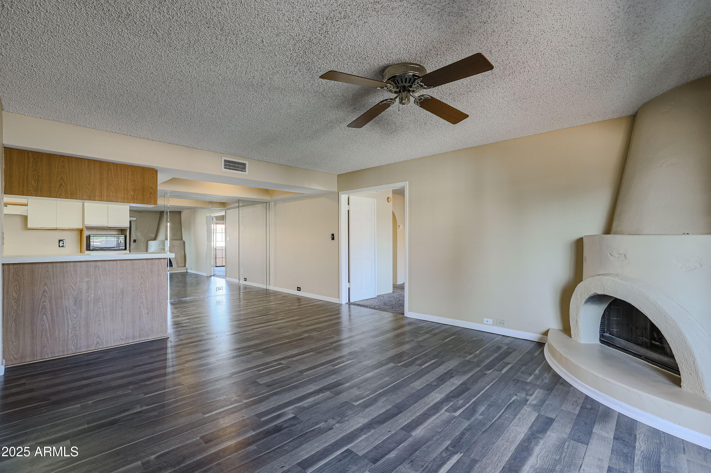 10410 North Cave Creek Road, Unit 2220 Phoenix, AZ 85020 - Photo 6 of 33 a view of a livingroom with wooden floor and a ceiling fan