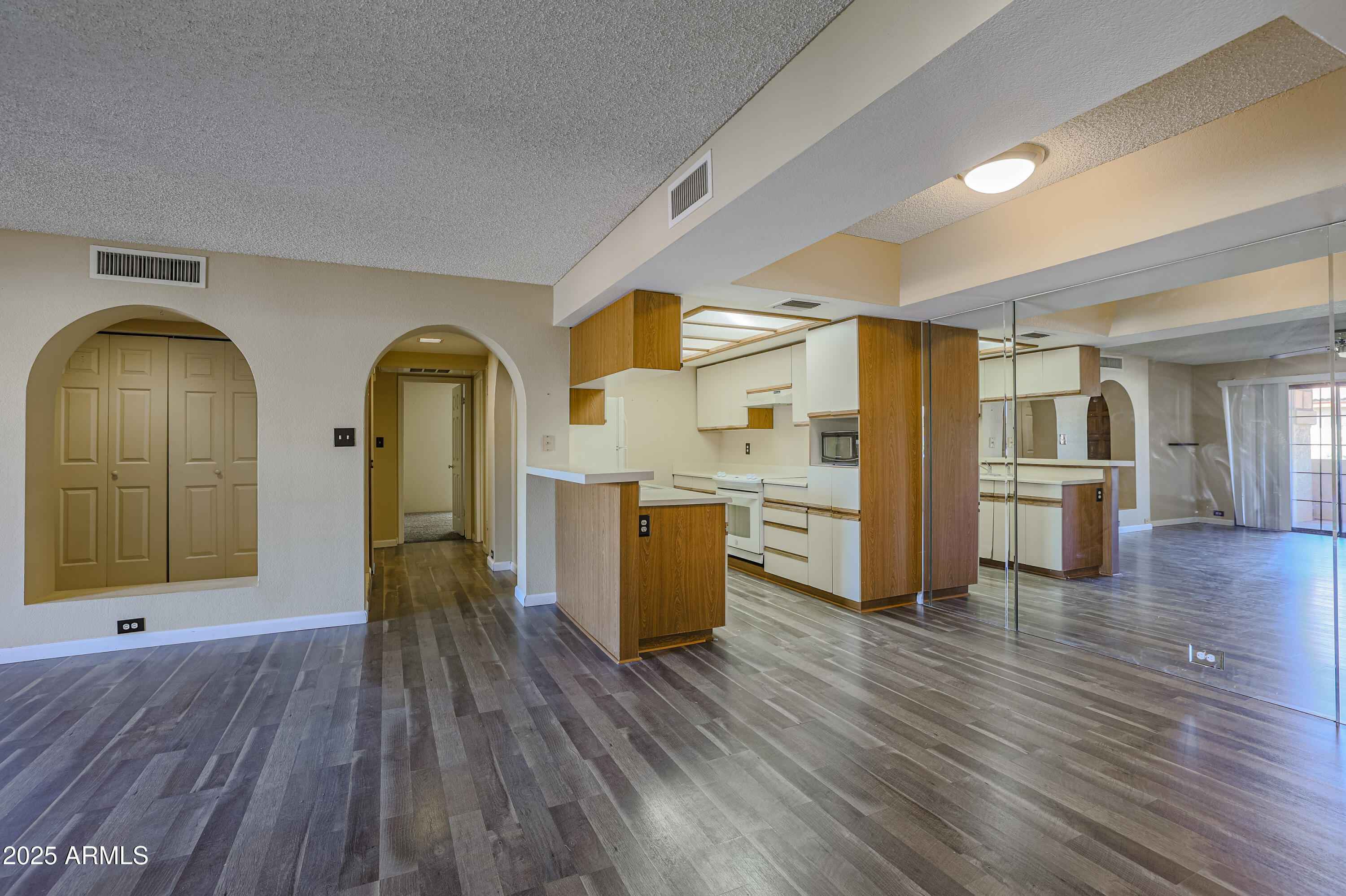 10410 North Cave Creek Road, Unit 2220 Phoenix, AZ 85020 - Photo 7 of 33 a view of a living room with kitchen view and wooden floor