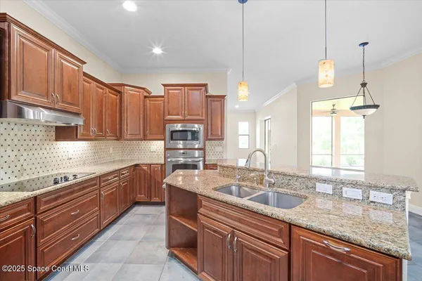 a kitchen with granite countertop cabinets stainless steel appliances and a counter space