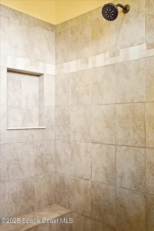 a bathroom with a sink a mirror a toilet and a shower