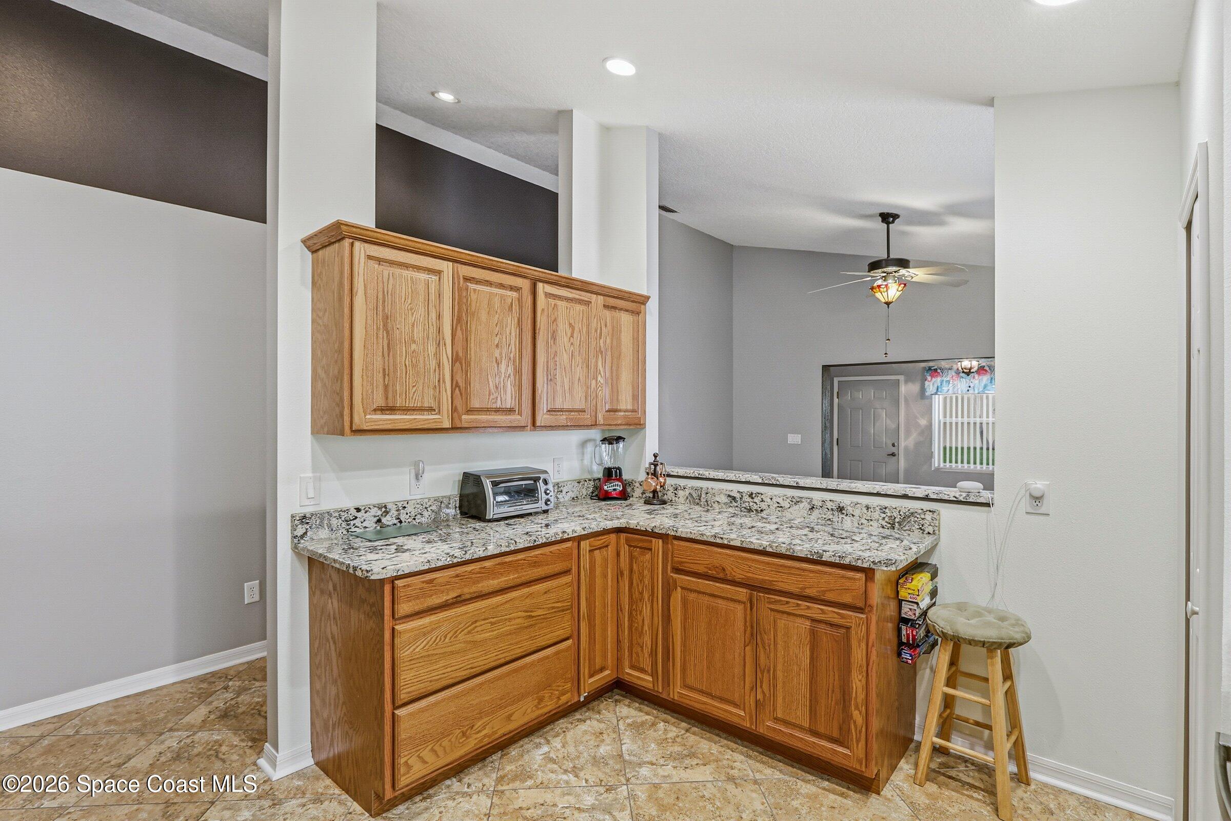 934 South Fork Circle Melbourne, FL 32901 - Photo 16 of 60 a bathroom with a granite countertop sink and a mirror