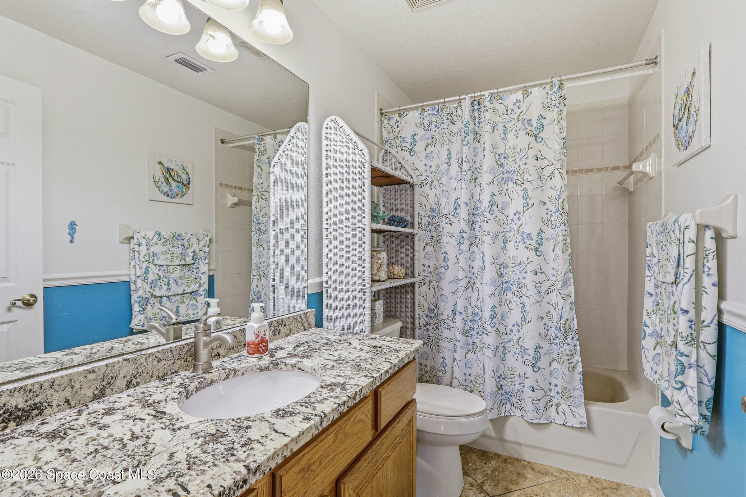 934 South Fork Circle Melbourne, FL 32901 - Photo 18 of 60 a bathroom with a granite countertop sink toilet and shower